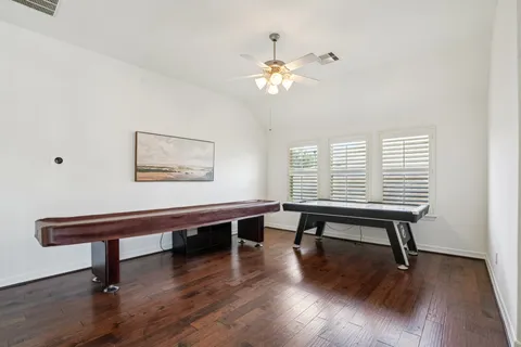a bathroom with a sink a toilet a mirror and shower