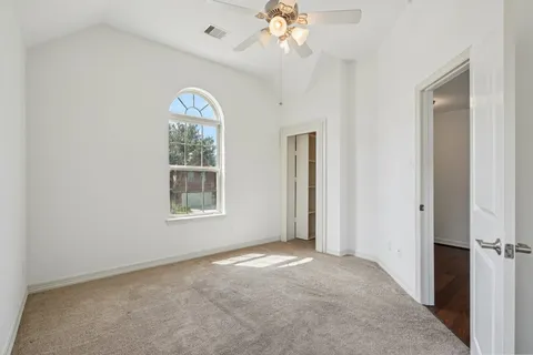 a view of a livingroom with wooden floor and a ceiling fan