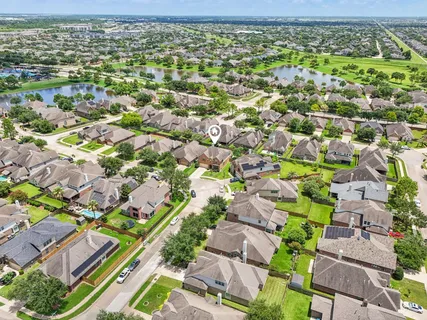 a view of a house with a yard and large tree
