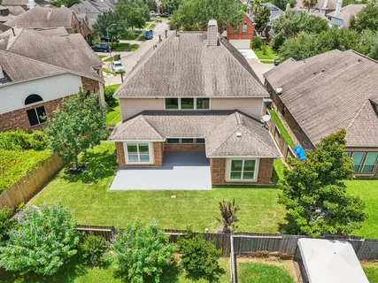 an aerial view of residential houses with outdoor space
