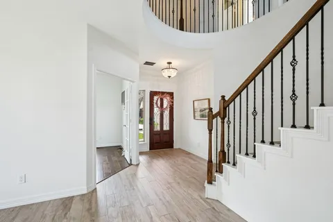 a front view of a house with a yard and plants