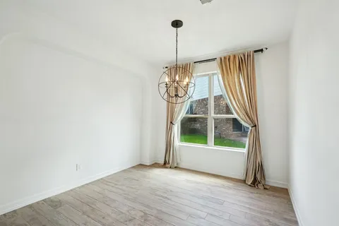 a view of wooden floor chandelier and entryway