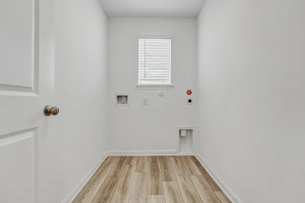 a view of a room with rack on the wall and a window
