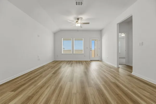 wooden floor in an empty room with a window