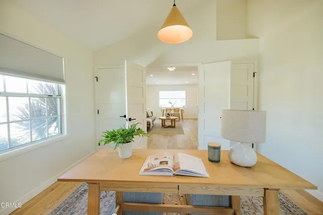 a living room with furniture and a potted plant