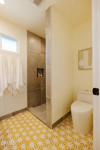 a bathroom with a sink mirror and a shower