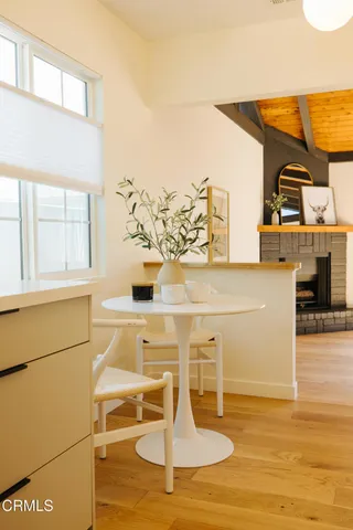 a living room with furniture a fireplace and a large window