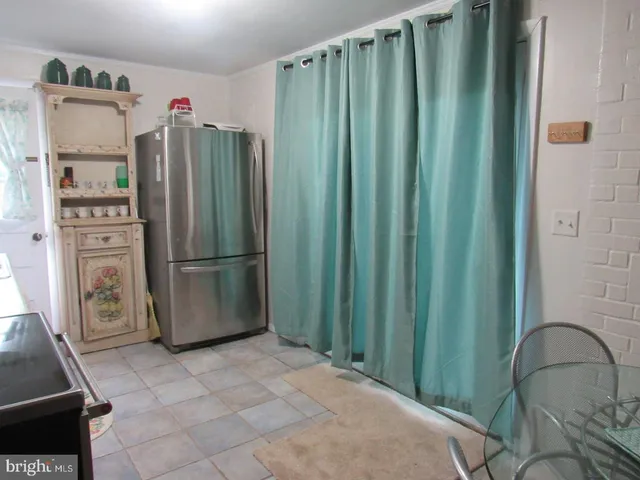 a kitchen with refrigerator a washer and dryer