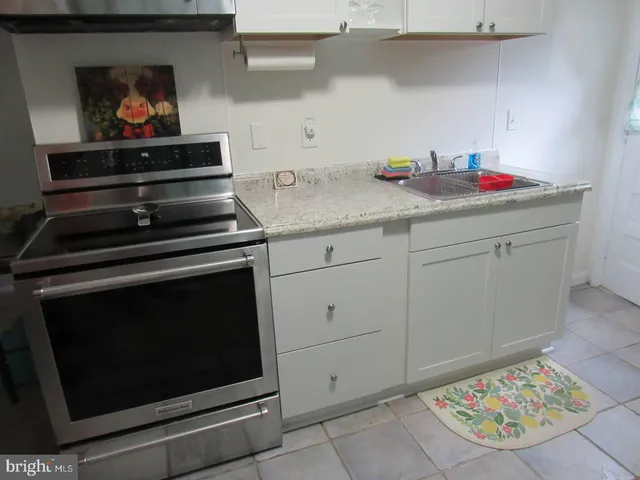 a kitchen with stainless steel appliances a stove and cabinets