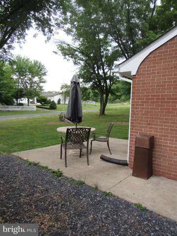 a view of a garden with furniture