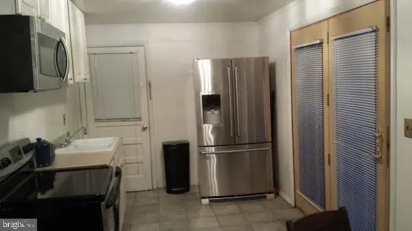 a kitchen with a refrigerator and a sink