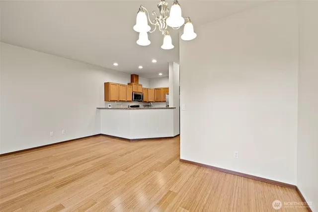 a view of a kitchen with a microwave and wooden floor