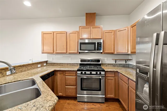 a kitchen with a sink appliances and cabinets