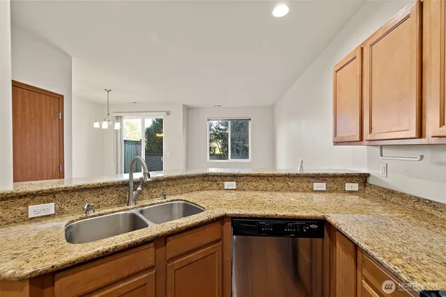 a kitchen with granite countertop a sink and a window