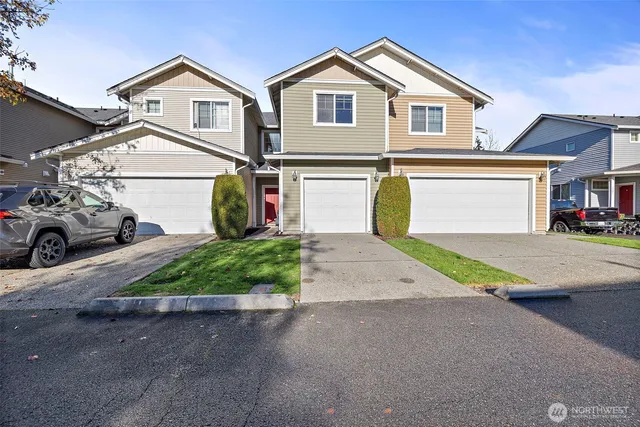 a front view of a house with a yard and garage