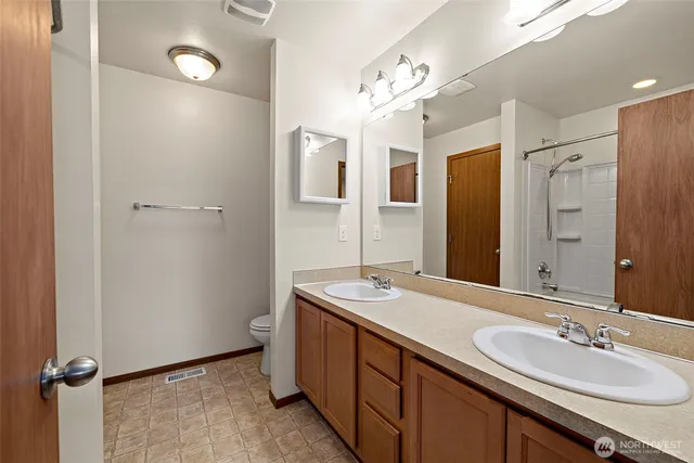 a spacious bathroom with a double vanity sink mirror and double