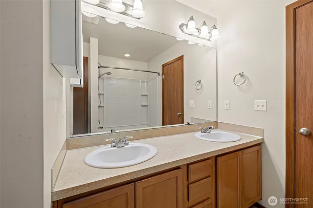 a bathroom with a sink double vanity and a mirror