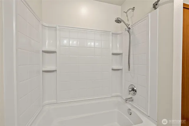 a bathroom with a bathtub and a shower