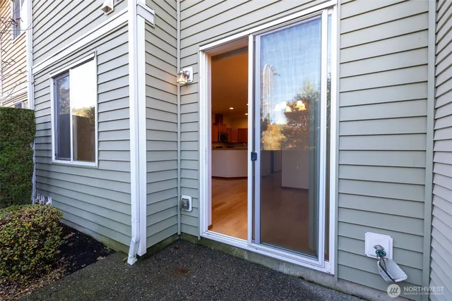 a view of a porch with a door and a tree