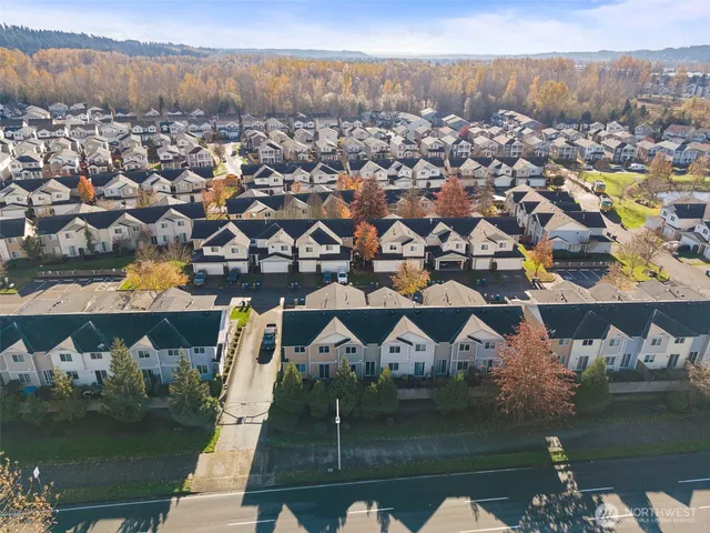 an aerial view of residential houses with outdoor space