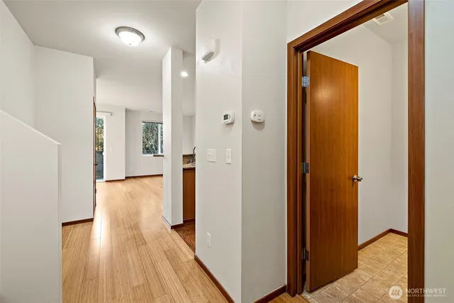 a view of a hallway with wooden floor