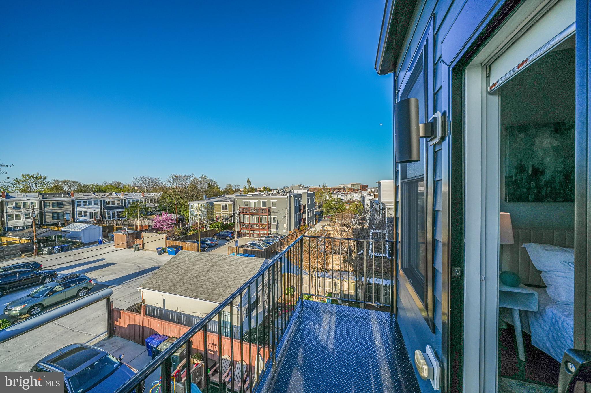 1728 D Street Southeast Washington, DC 20003 - Photo 13 of 42 a view of a balcony with wooden floor and city view