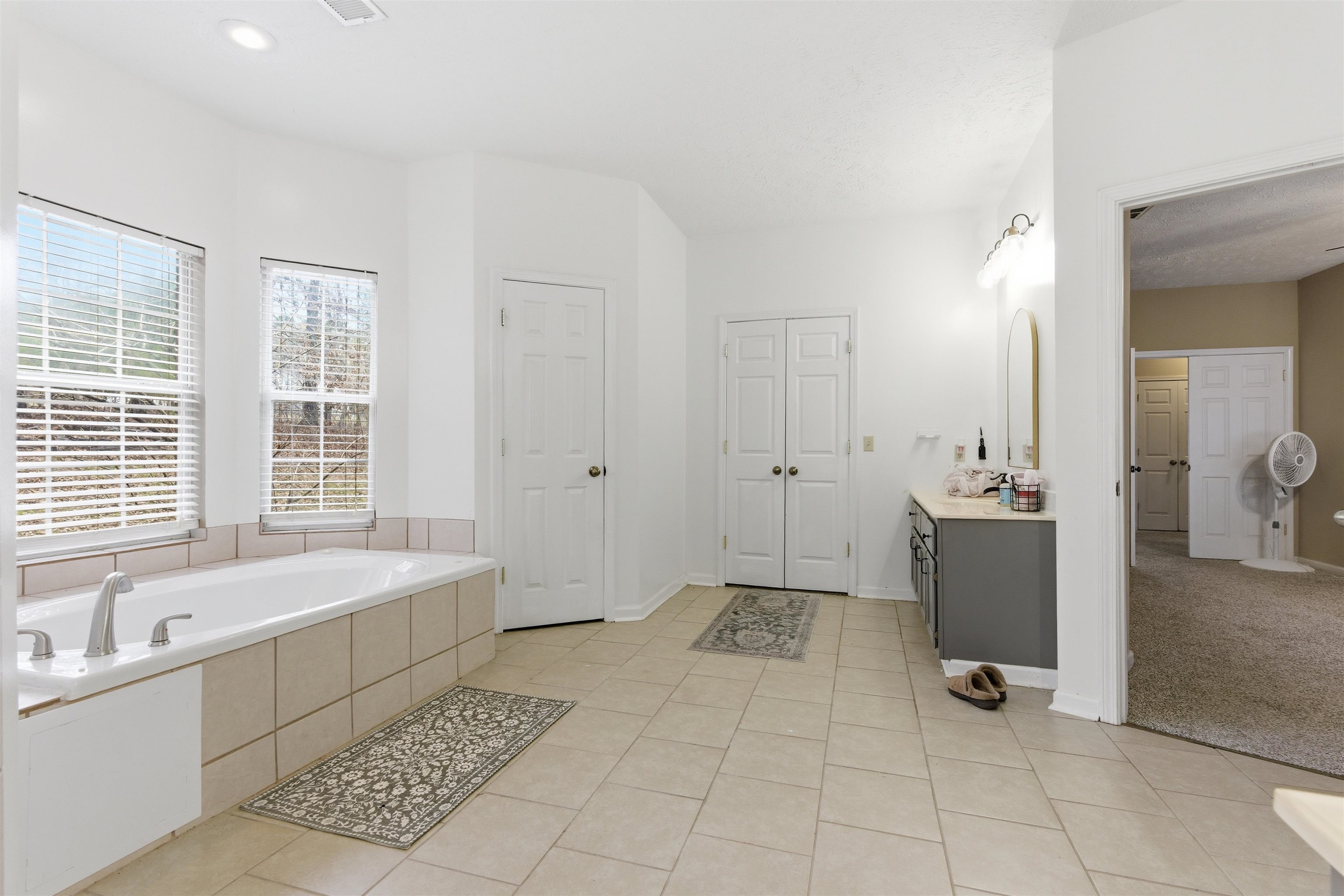 915 Cliffview Road Bolivar, TN 38008 - Photo 19 of 35 Bathroom featuring a garden tub, light tile patterned flooring, and vanity