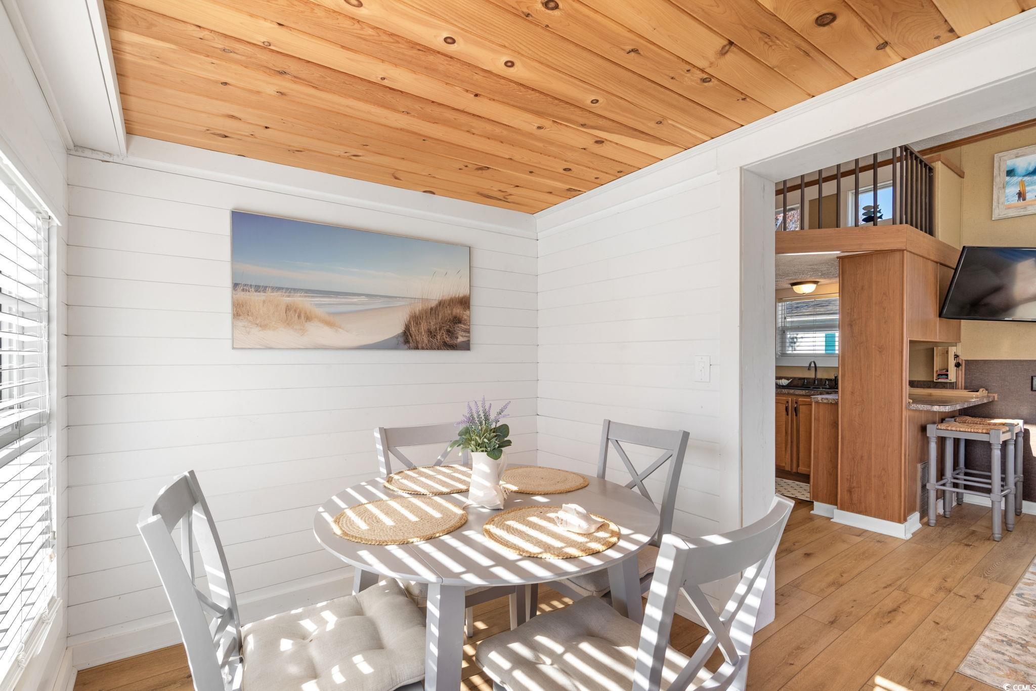 137 Riptide Circle North Myrtle Beach, SC 29582 - Photo 11 of 32 Dining space featuring wooden ceiling, light wood-type flooring, and wood walls