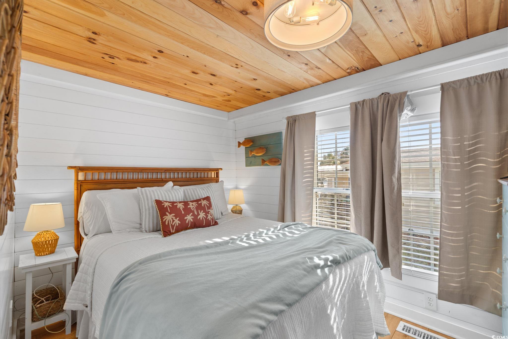 137 Riptide Circle North Myrtle Beach, SC 29582 - Photo 17 of 32 Bedroom with wood ceiling, wood finished floors, and wood walls