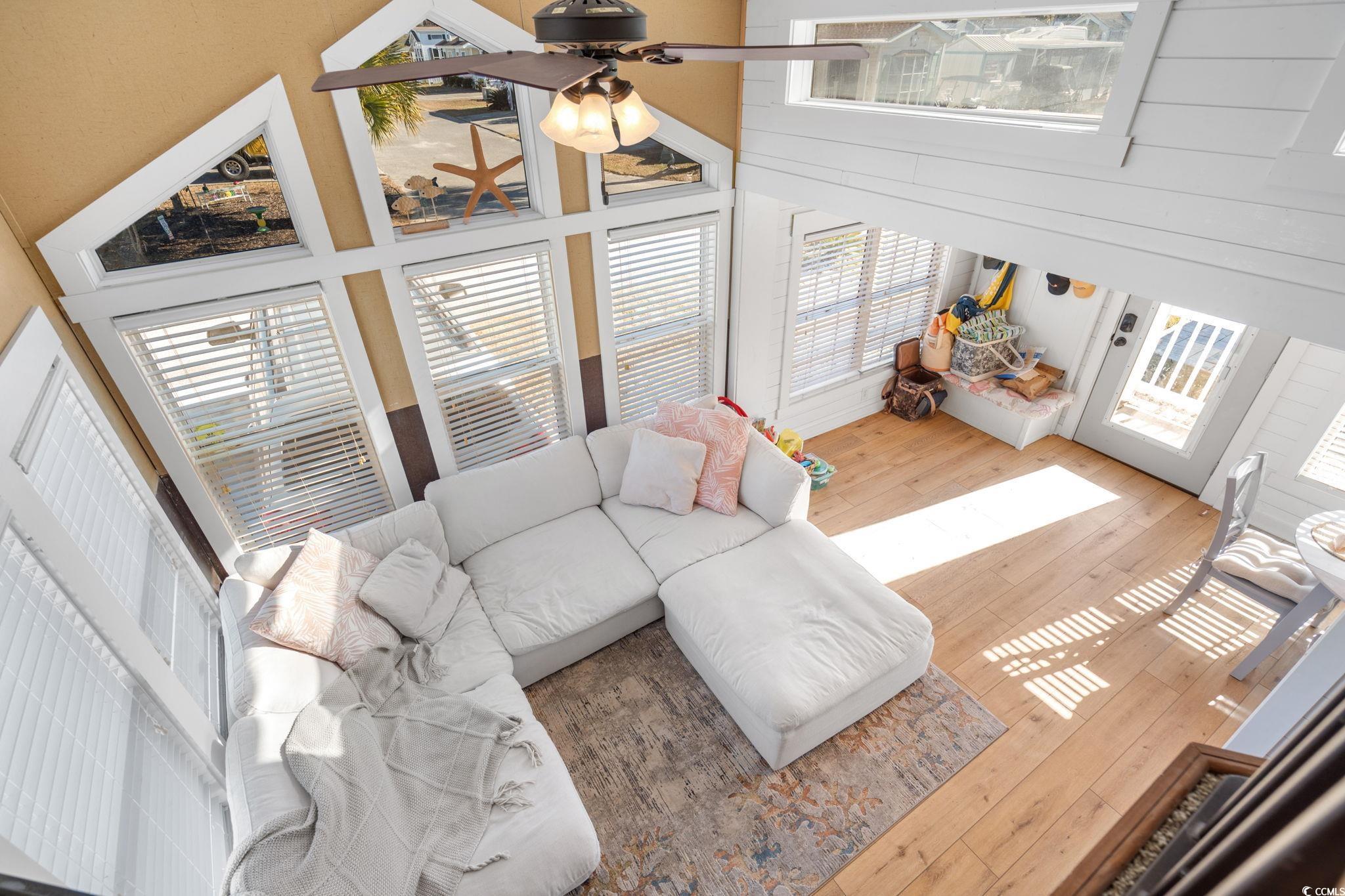 137 Riptide Circle North Myrtle Beach, SC 29582 - Photo 22 of 32 Living room with a high ceiling, hardwood / wood-style flooring, and plenty of natural light