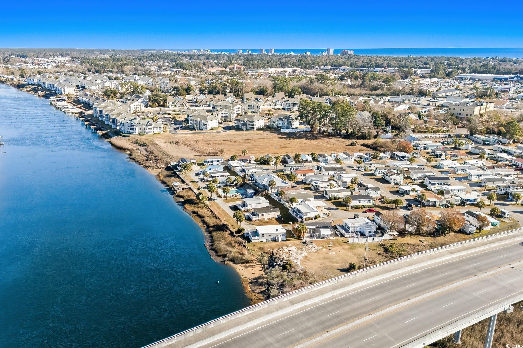 137 Riptide Circle North Myrtle Beach, SC 29582 - Photo 27 of 32 Aerial overview of property's location with a large body of water and nearby suburban area
