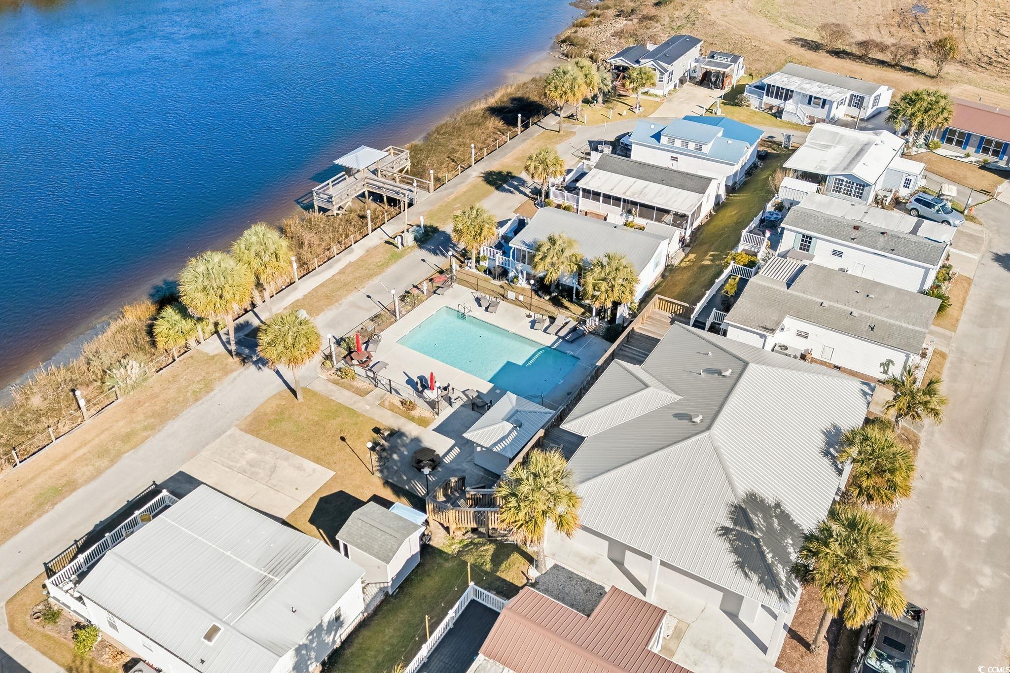 137 Riptide Circle North Myrtle Beach, SC 29582 - Photo 29 of 32 Aerial view of residential area featuring a large body of water and a pool area
