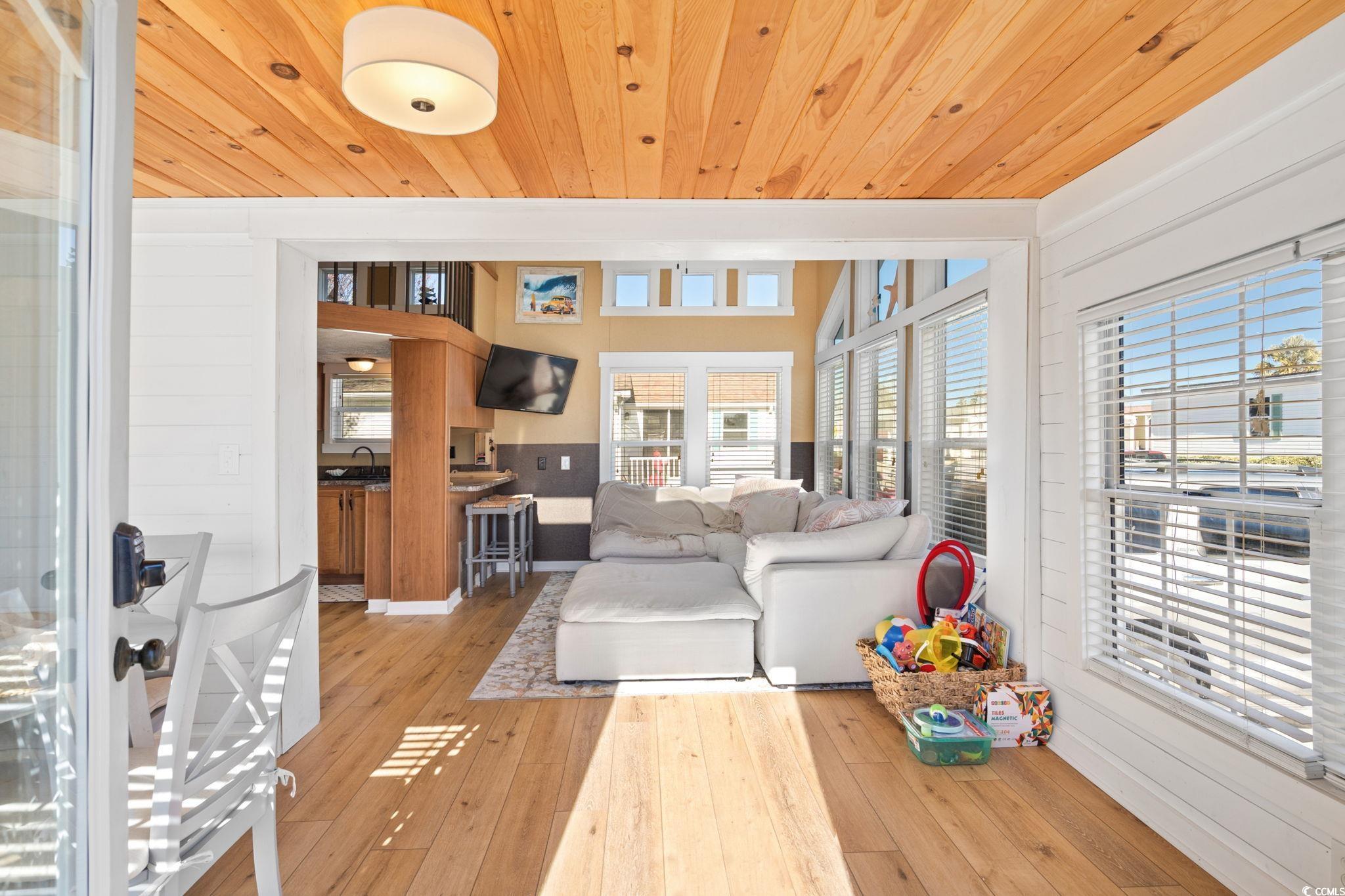 137 Riptide Circle North Myrtle Beach, SC 29582 - Photo 5 of 32 Living area featuring light wood-type flooring, wooden ceiling, and wood walls