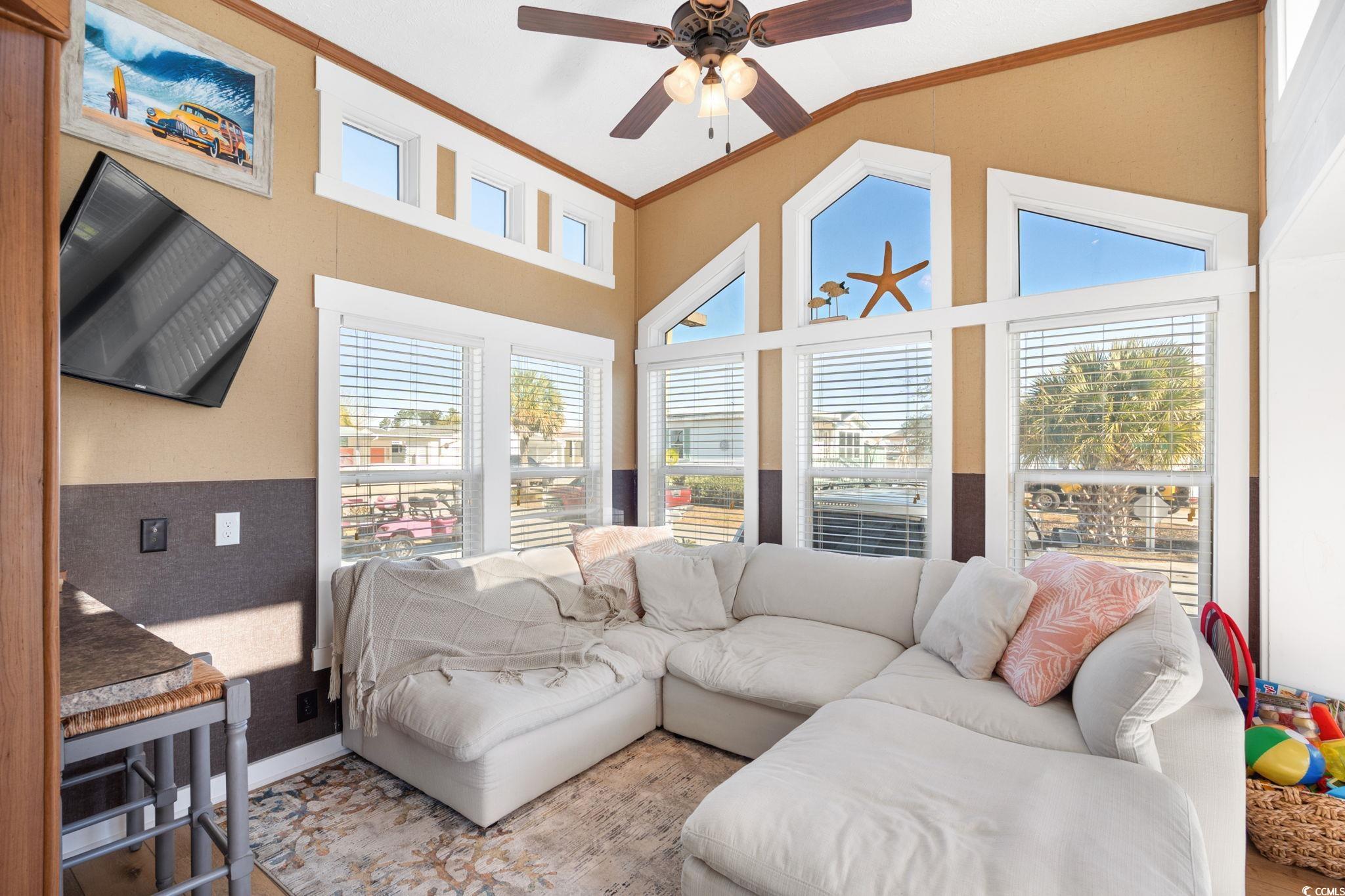 137 Riptide Circle North Myrtle Beach, SC 29582 - Photo 7 of 32 Living room featuring ceiling fan, ornamental molding, and high vaulted ceiling