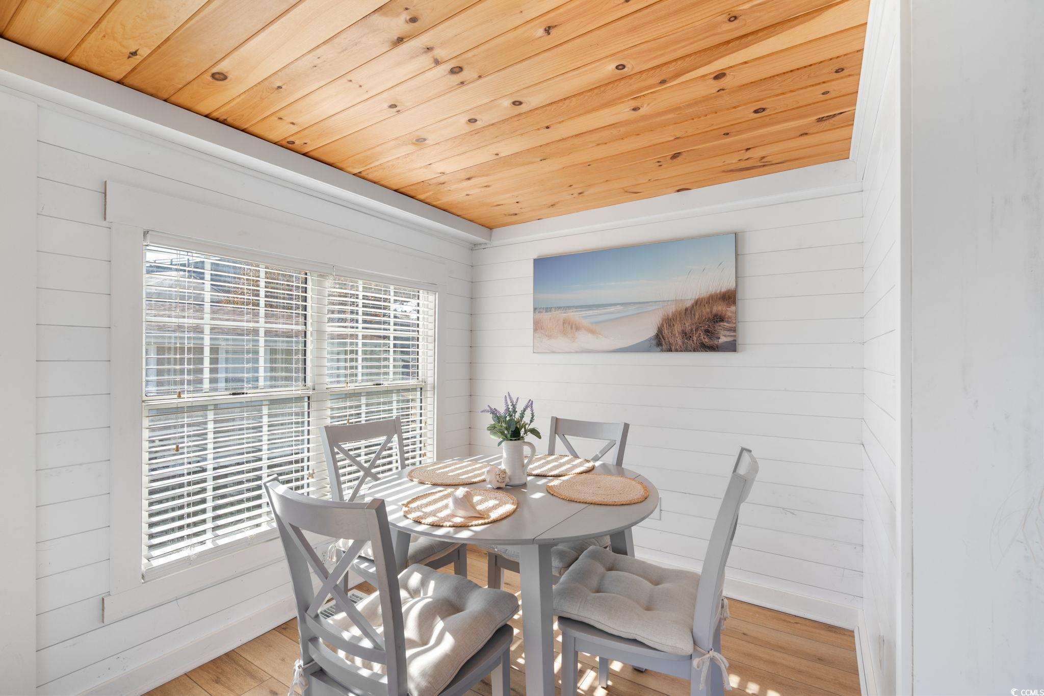 137 Riptide Circle North Myrtle Beach, SC 29582 - Photo 10 of 32 Dining room featuring wood ceiling, wood walls, and light wood-style flooring