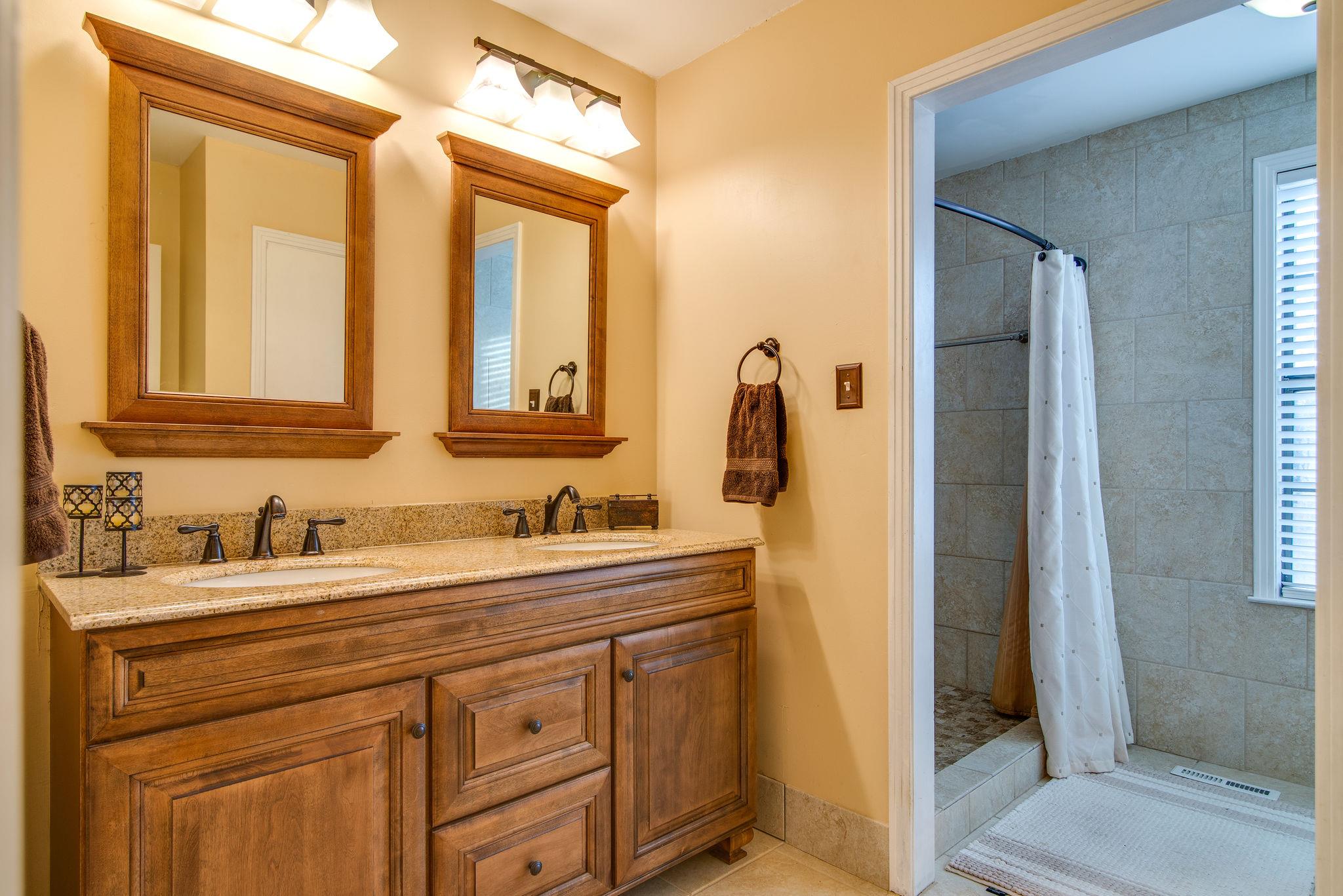 3681 Cairo Bend Road Lebanon, TN 37087 - Photo 10 of 23 a bathroom with a double vanity sink and a mirror