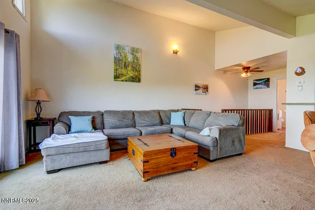 a living room with furniture and a lamp