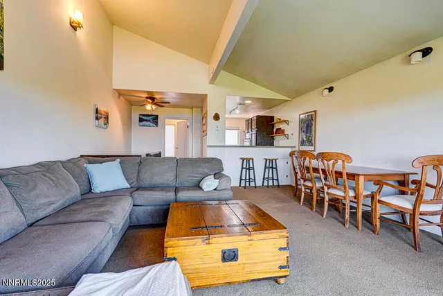 a living room with furniture and kitchen view