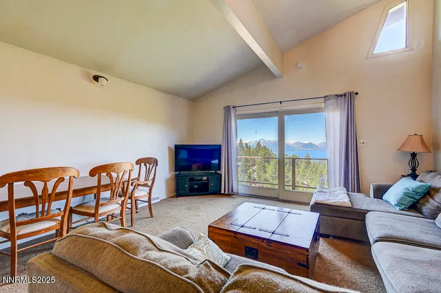 a living room with furniture and a floor to ceiling window