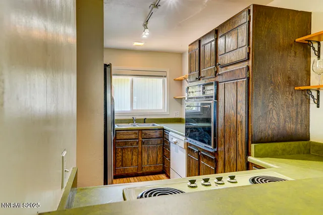 a kitchen with stainless steel appliances granite countertop a refrigerator and a stove