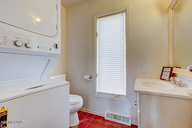 a bathroom with a sink toilet and a window