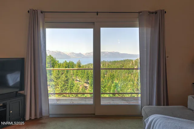 a view of a bedroom with a large window and a bed