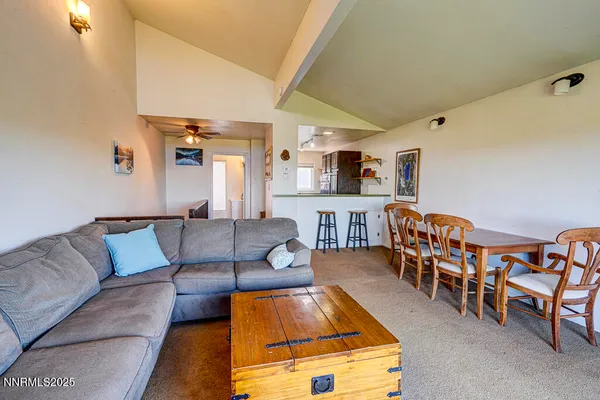 a living room with furniture kitchen view and a couch