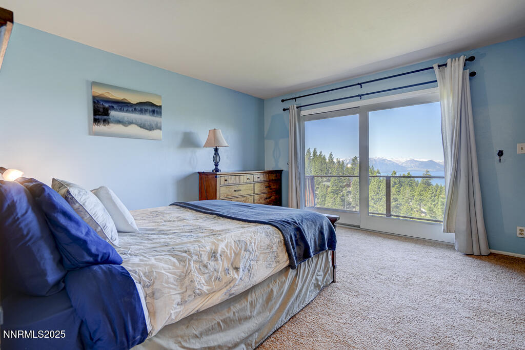 710 Tina Court, Unit B2 Stateline, NV 89449 - Photo 7 of 25 a bedroom with a large bed and a large window