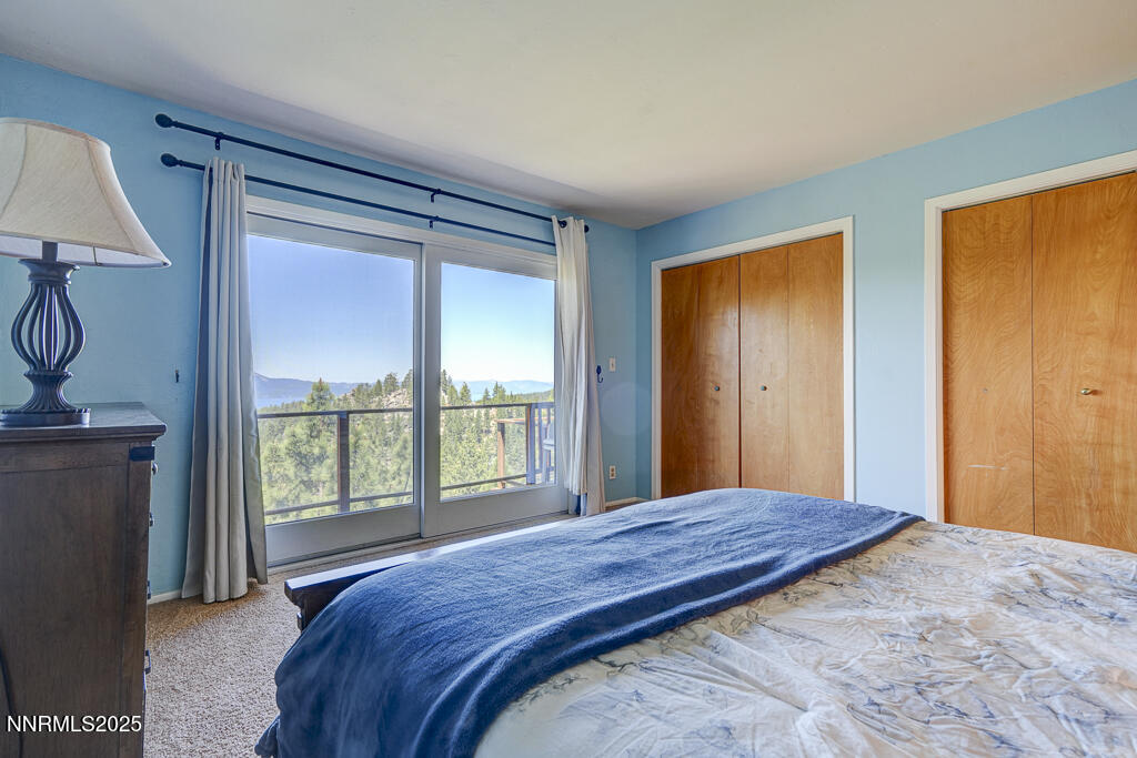 710 Tina Court, Unit B2 Stateline, NV 89449 - Photo 8 of 25 a bedroom with a large bed and a window