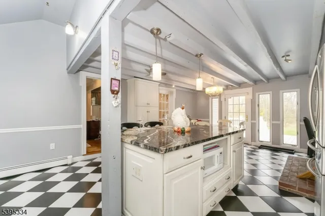 a kitchen with stainless steel appliances kitchen island granite countertop a sink and cabinets