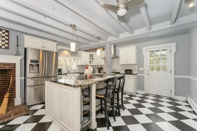 a kitchen with a sink a refrigerator and cabinets