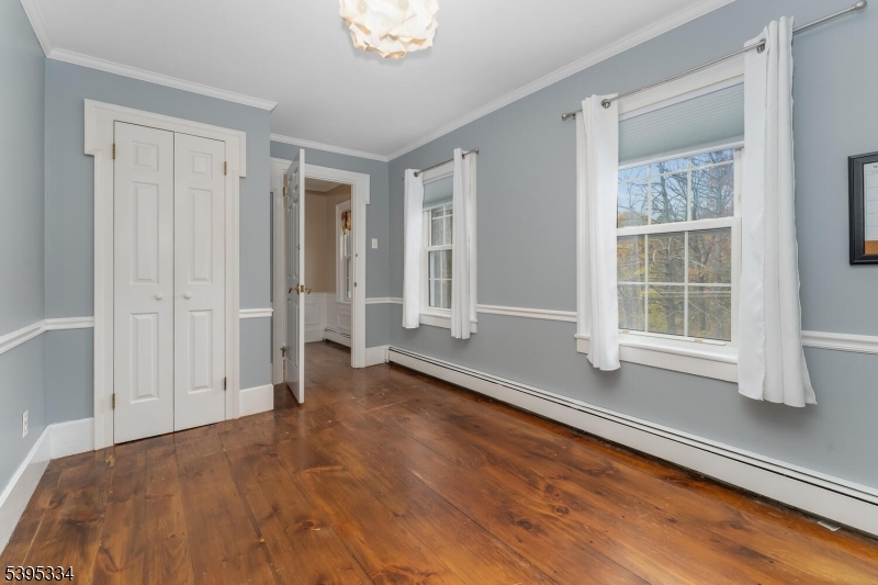 383 Pittstown Road Pittstown, NJ 08867 - Photo 19 of 29 a view of an empty room with a window and wooden floor