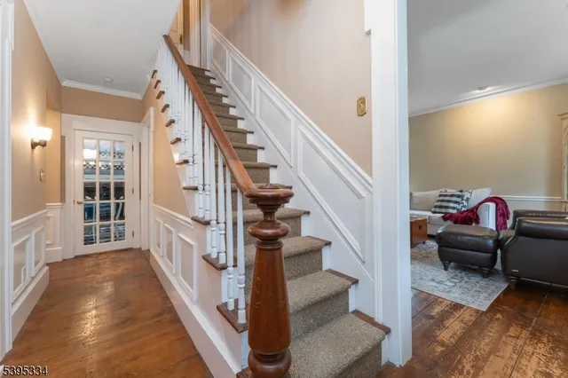a view of entryway and hall with wooden floor