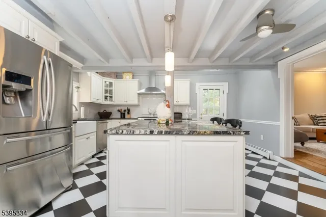 a kitchen with stainless steel appliances a sink a stove a refrigerator and cabinets